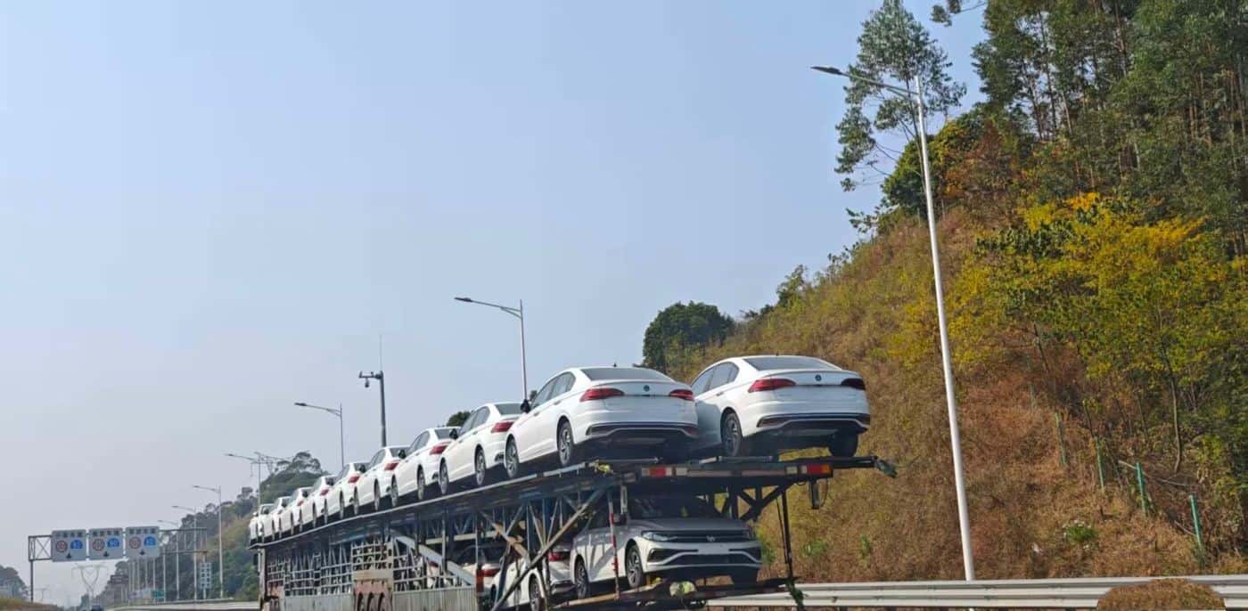 Car carrier transporting new vehicles by road